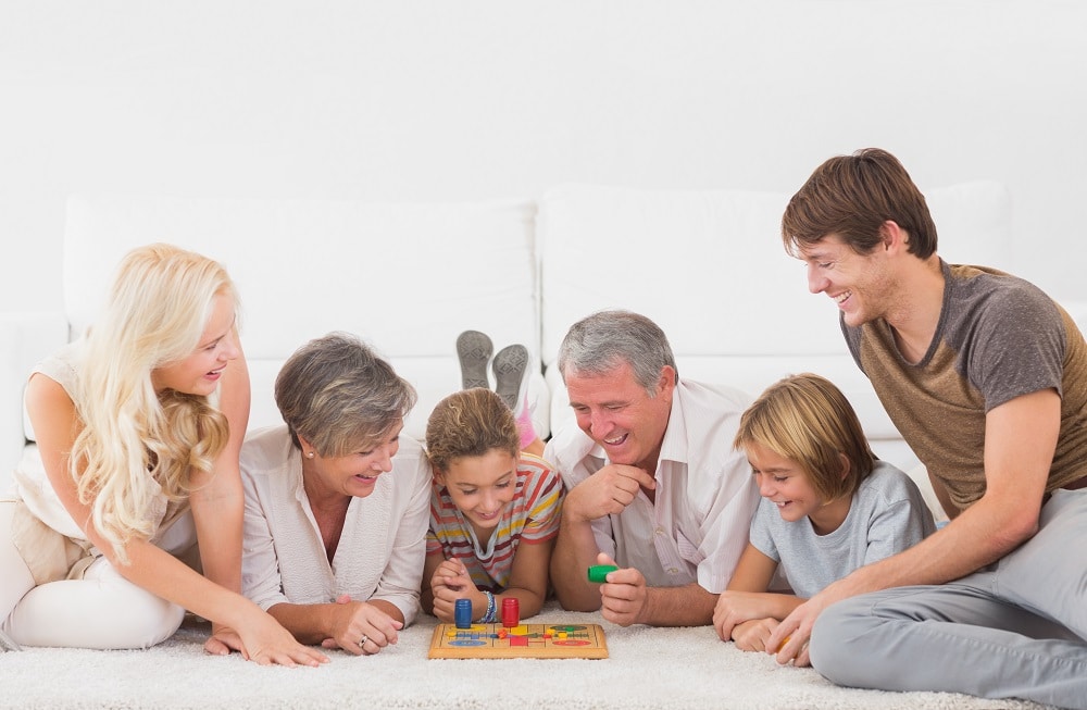 Family enjoying playing fun financial board games for kids