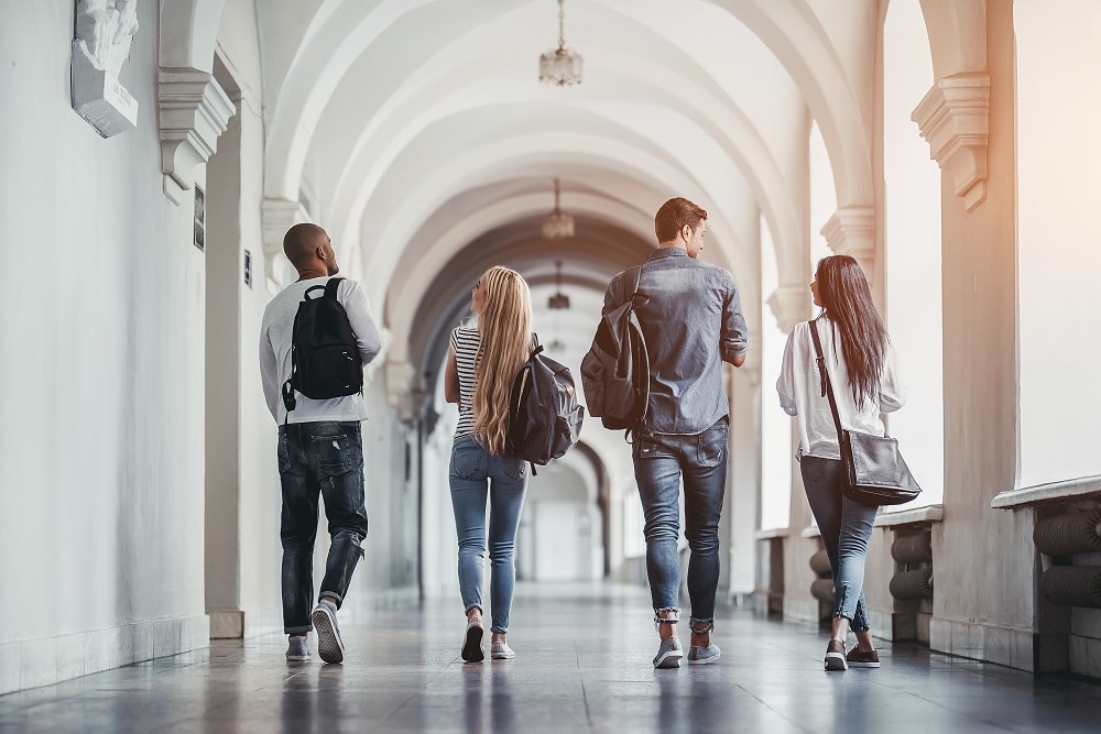 Four students in college finances, walking towards future, secure in their college finances and beyond